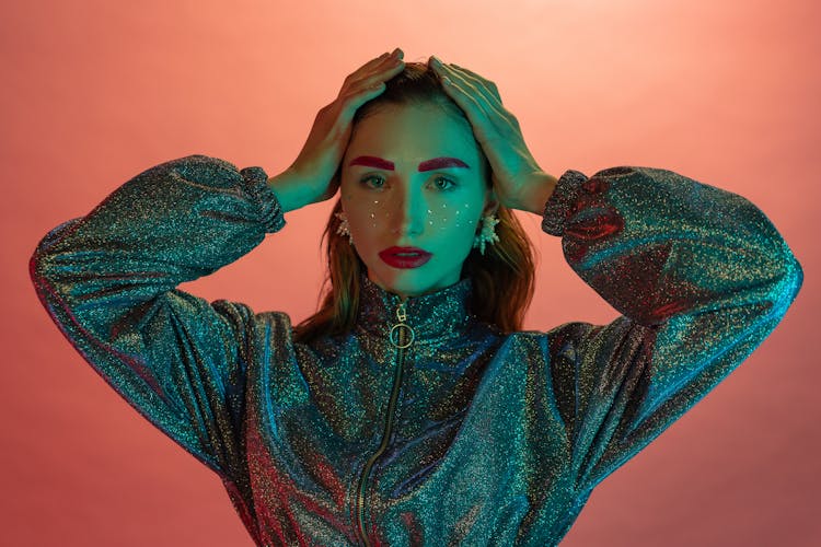 Woman With Sequence On Face And Red Lipstick Touching Her Head