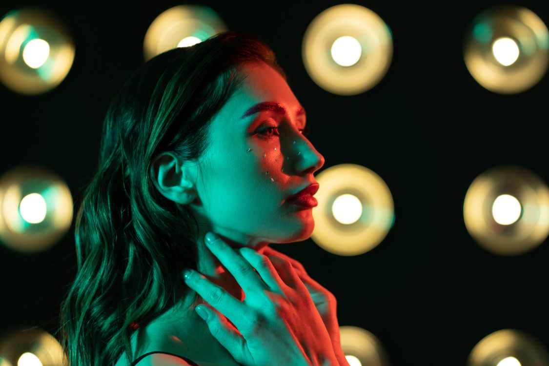 Woman With Red Light Reflection on Face · Free Stock Photo