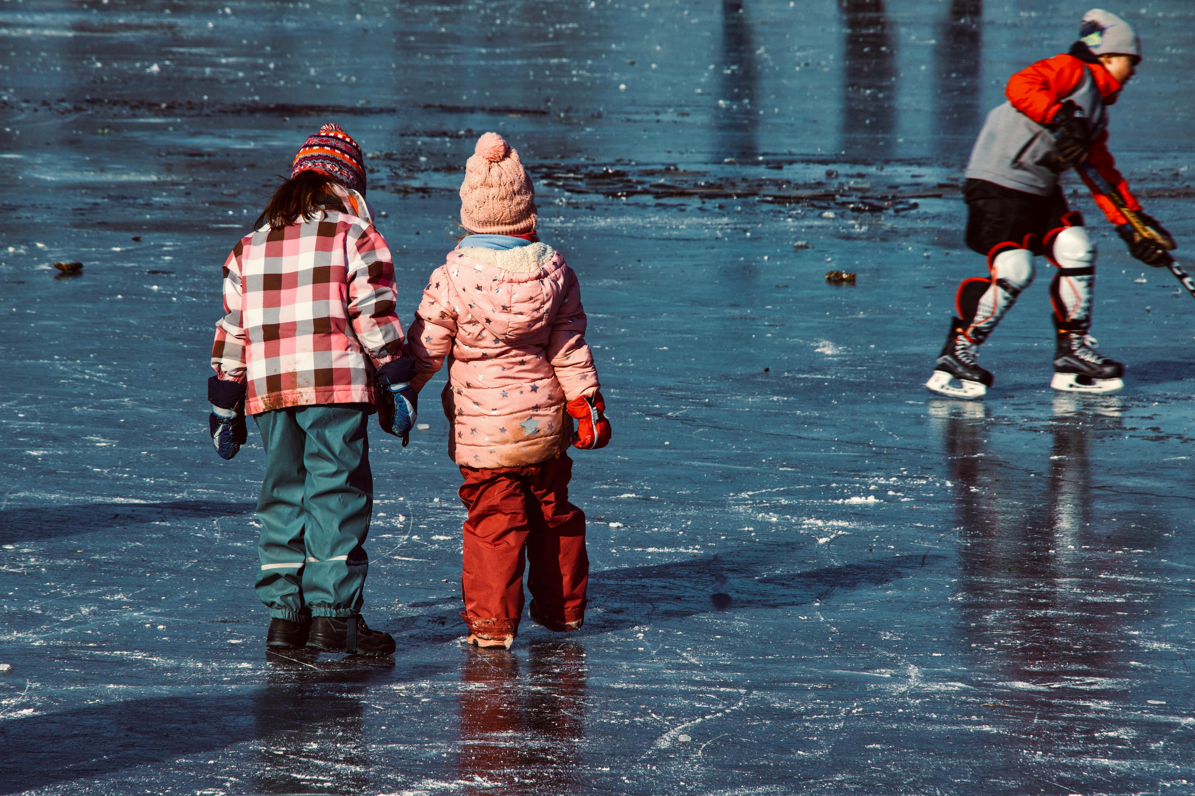 hockey player with unrecognizable girlfriends on rink outdoors