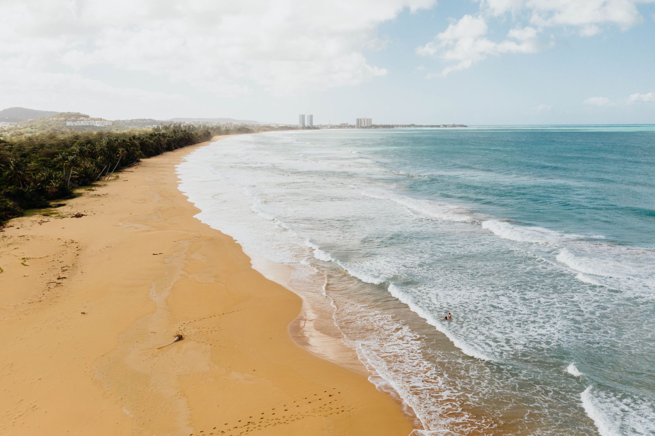 Leah Newhouse Golden sandy beach in Puerto Rico with gentle turquoise waves