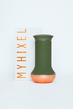 Green silicone pleasure device with orange base and packaging, ideal for adult use.