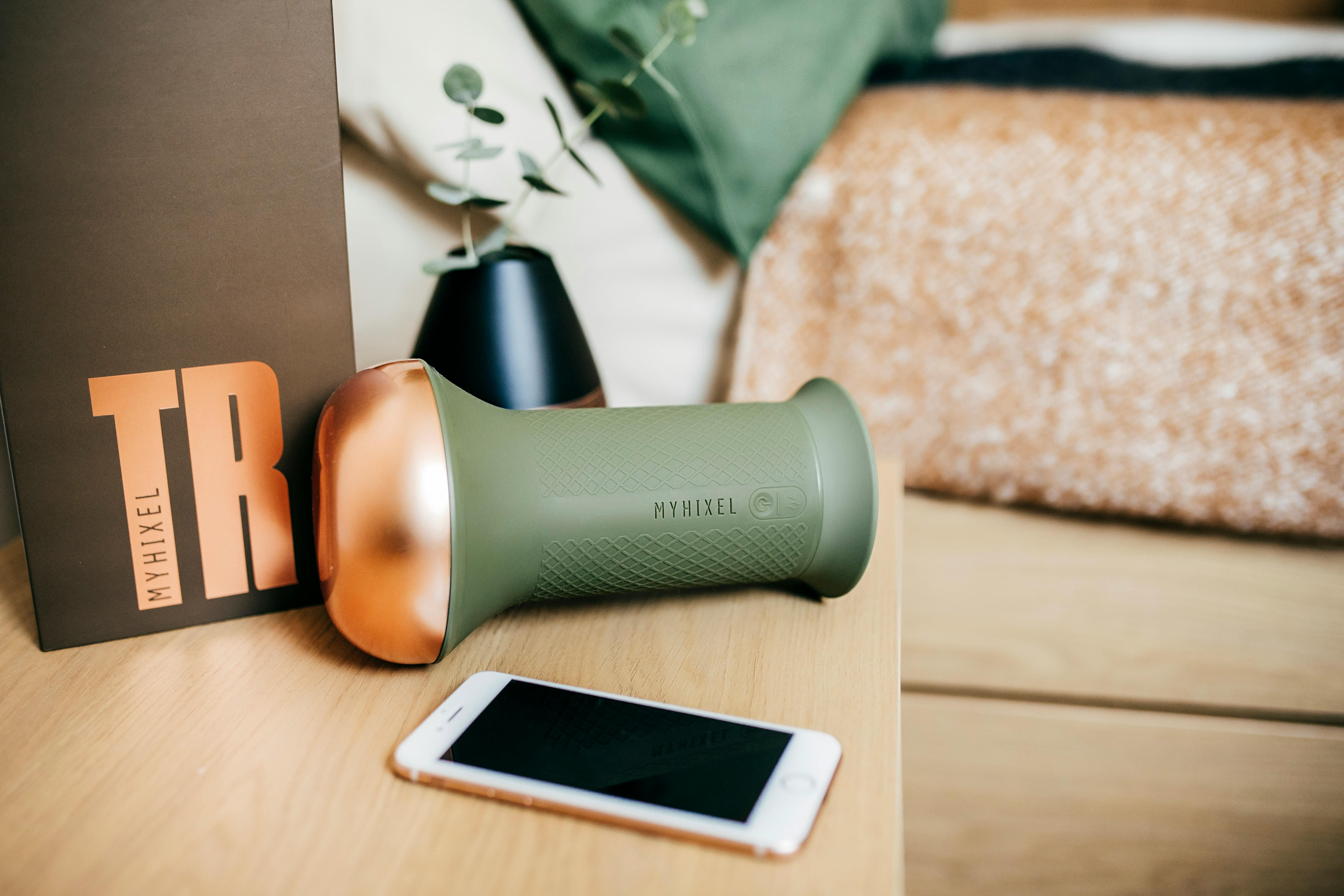 Sex Toy and Smartphone on a Wooden Surface · Free Stock Photo