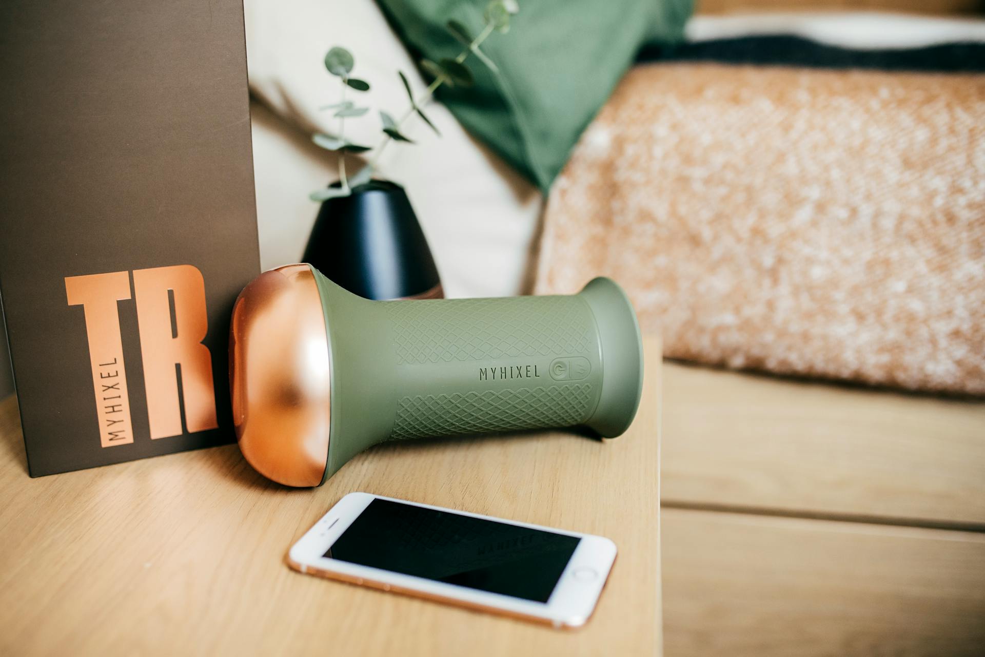 Myhixel TR device alongside packaging and smartphone on a bedside table.