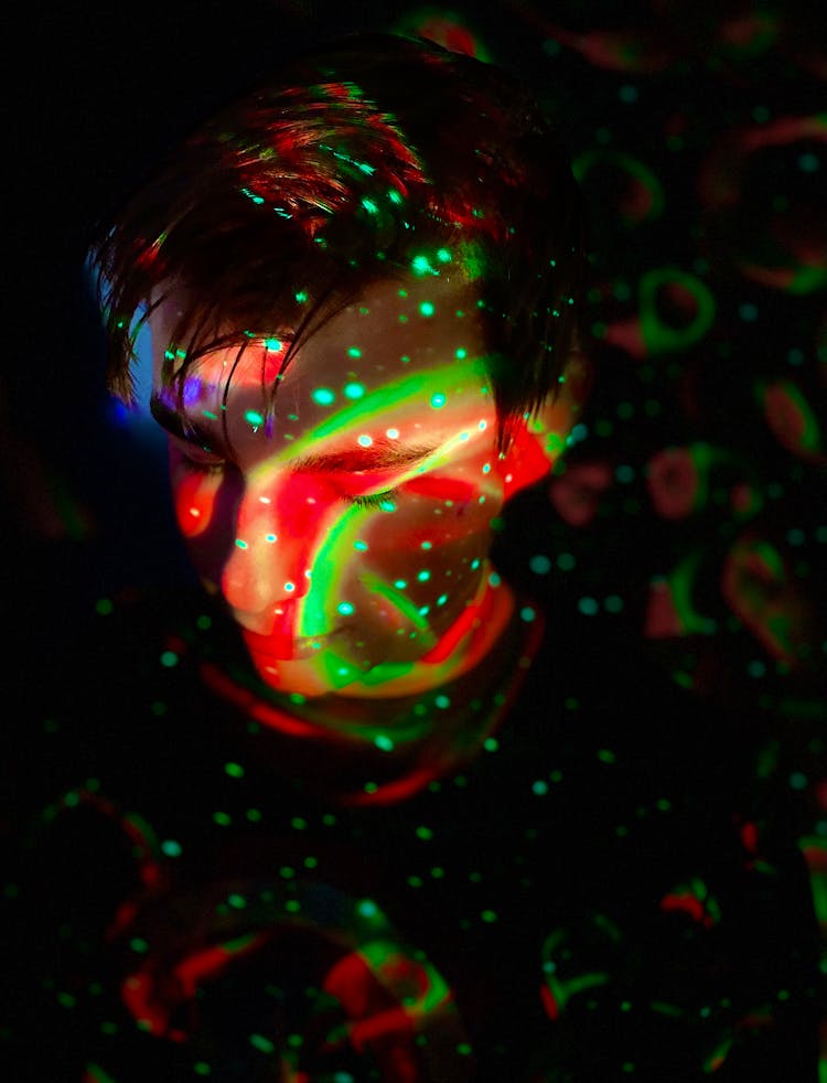 Red And Green Lights On A Man's Face