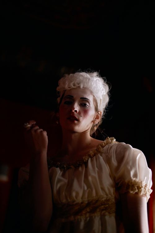 Free Elegant portrait of a person in historical dress with dramatic lighting. Stock Photo