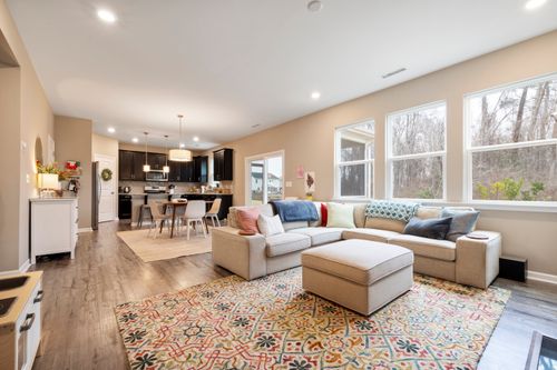 Free Bright and cozy open-plan living room featuring modern furniture and natural light. Stock Photo
