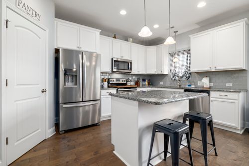 Free Sleek kitchen design featuring stainless steel appliances and white cabinetry. Stock Photo