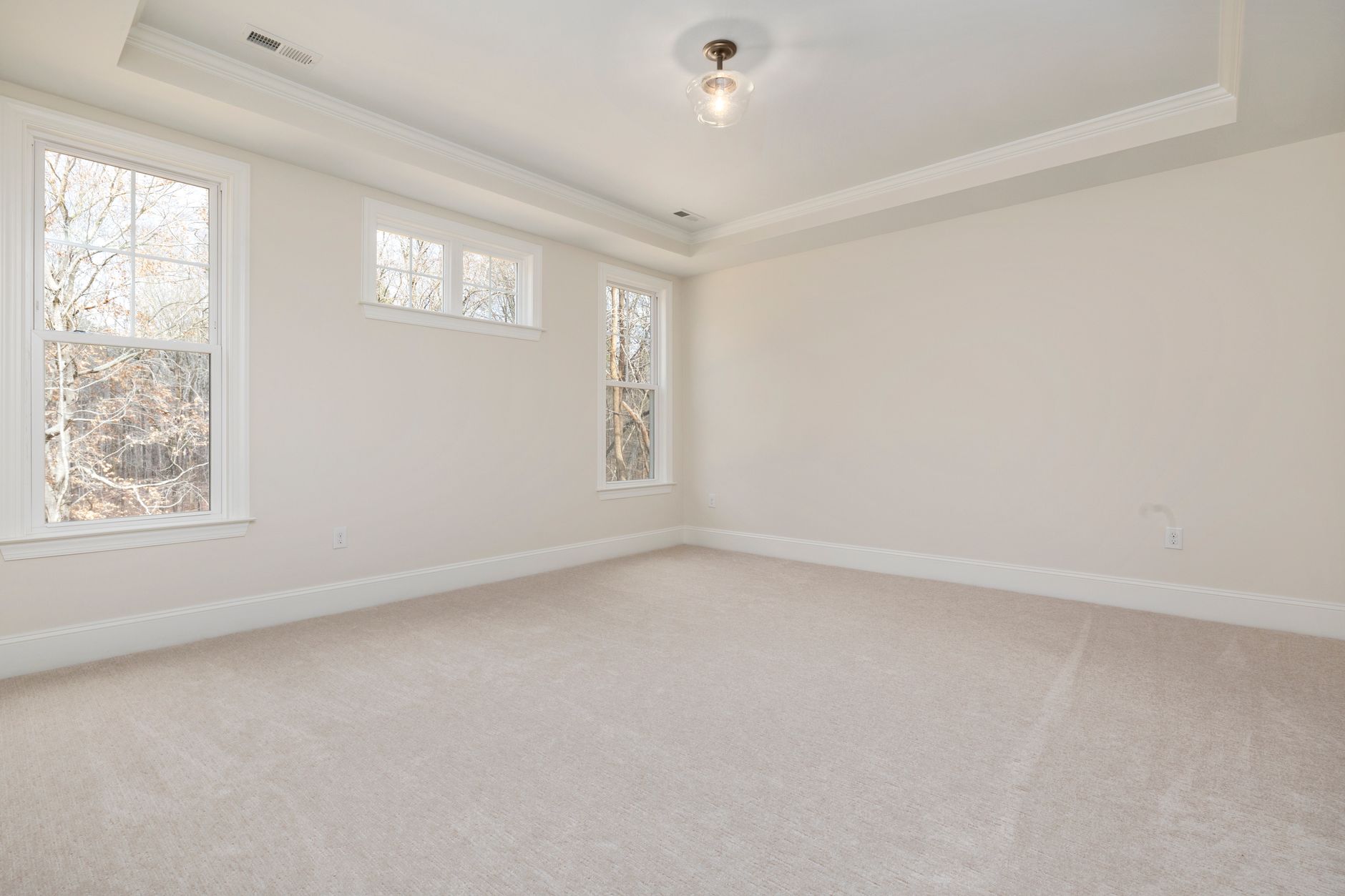 Bright empty room with large windows and neutral walls — choosing paint finishes and sheens for a San Diego home
