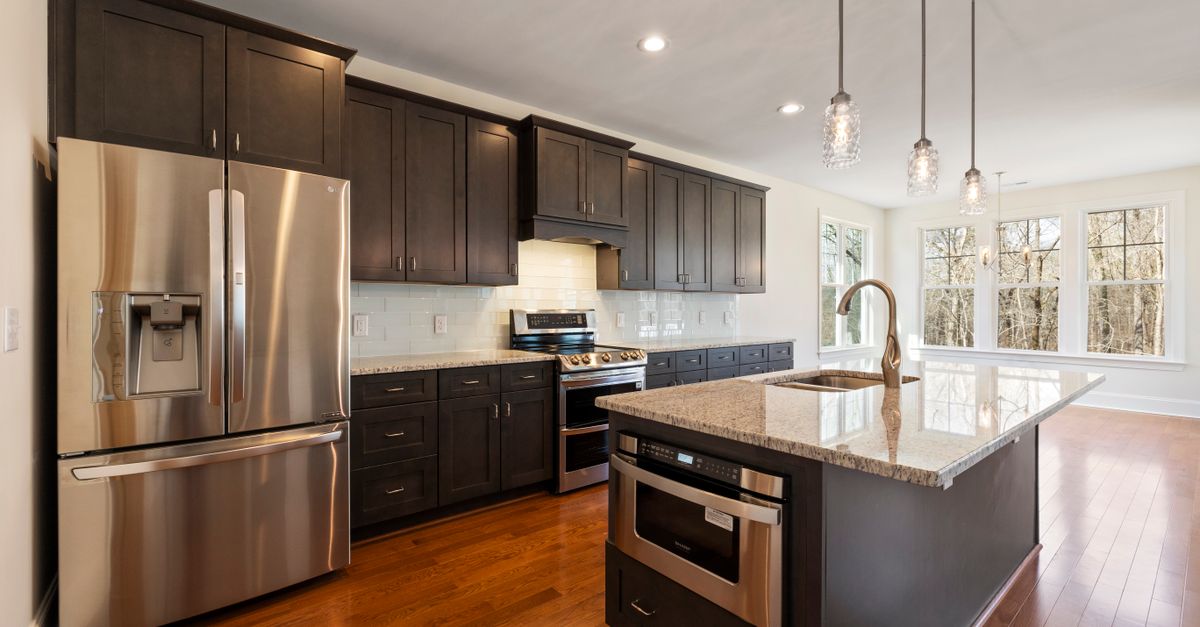 Bright and spacious kitchen featuring stainless steel appliances and a large island.