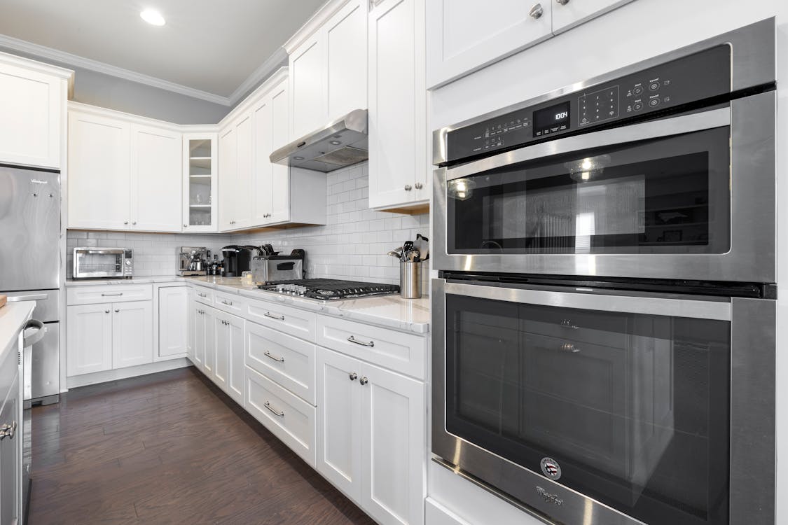 Silver and Black Oven on White Wooden Kitchen Cabinet