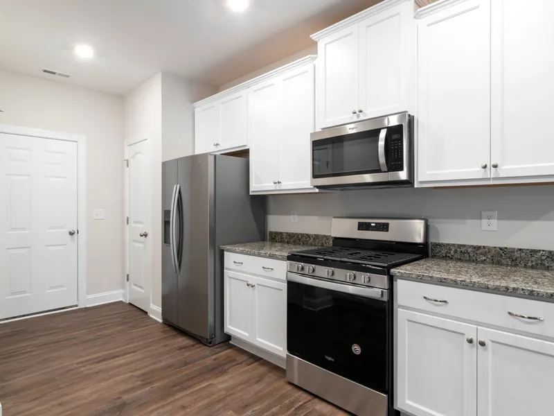 Kitchen with furniture and a refrigerator Kitchen with furniture and a refrigerator