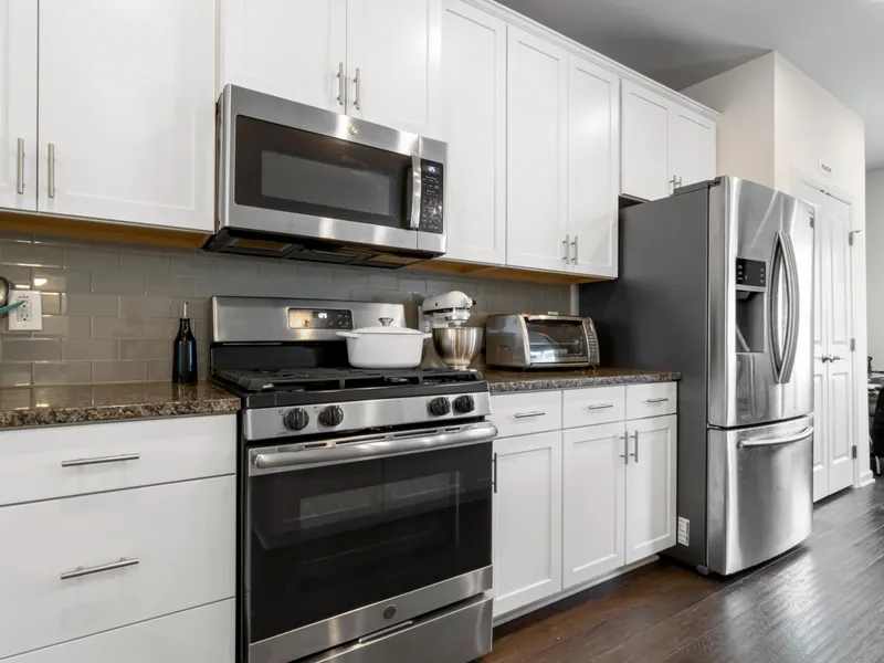 Kitchen with a refrigerator, oven and microwaves Kitchen with a refrigerator, oven and microwaves