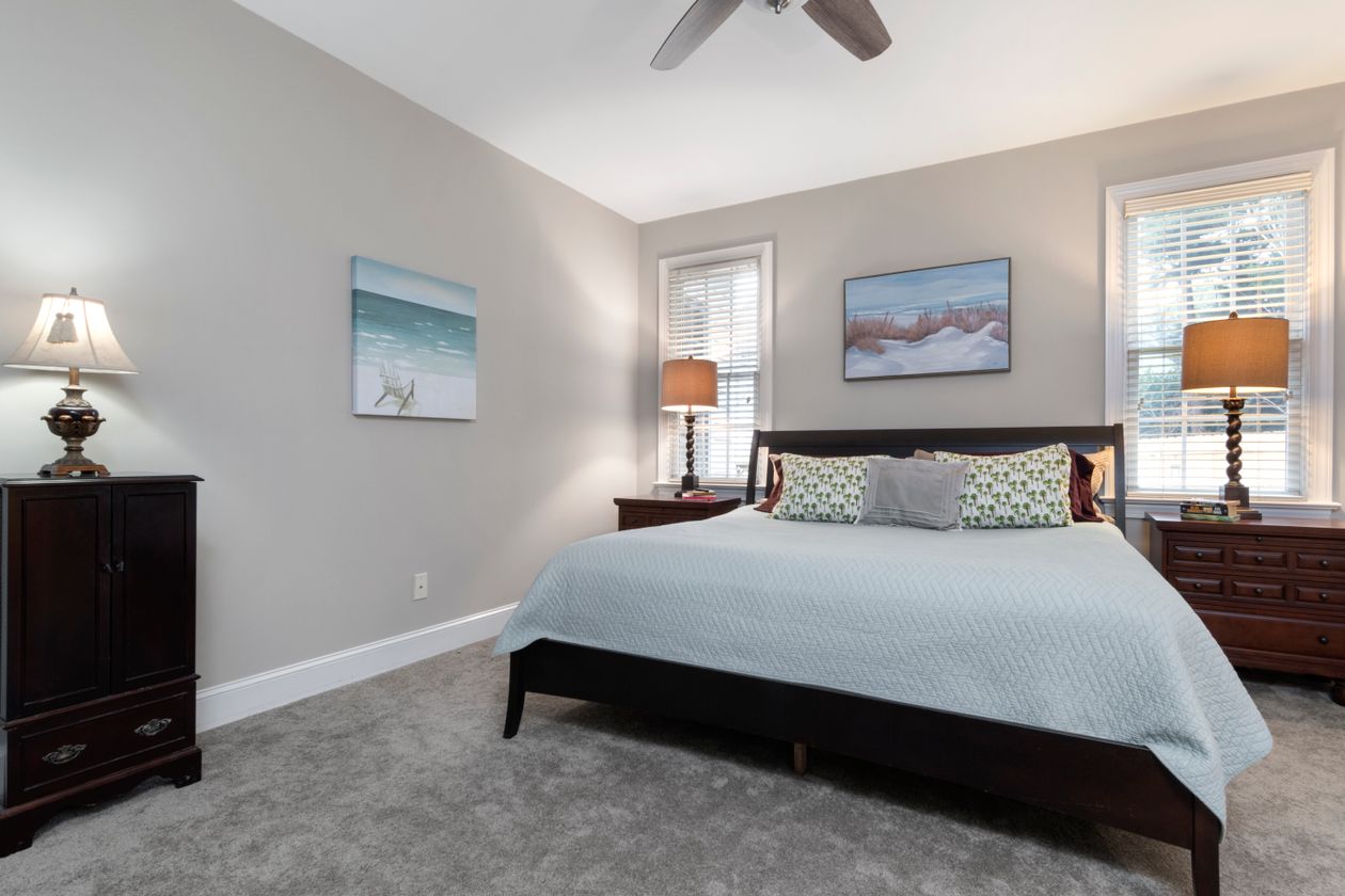 King bed with nightstands on a gray rug