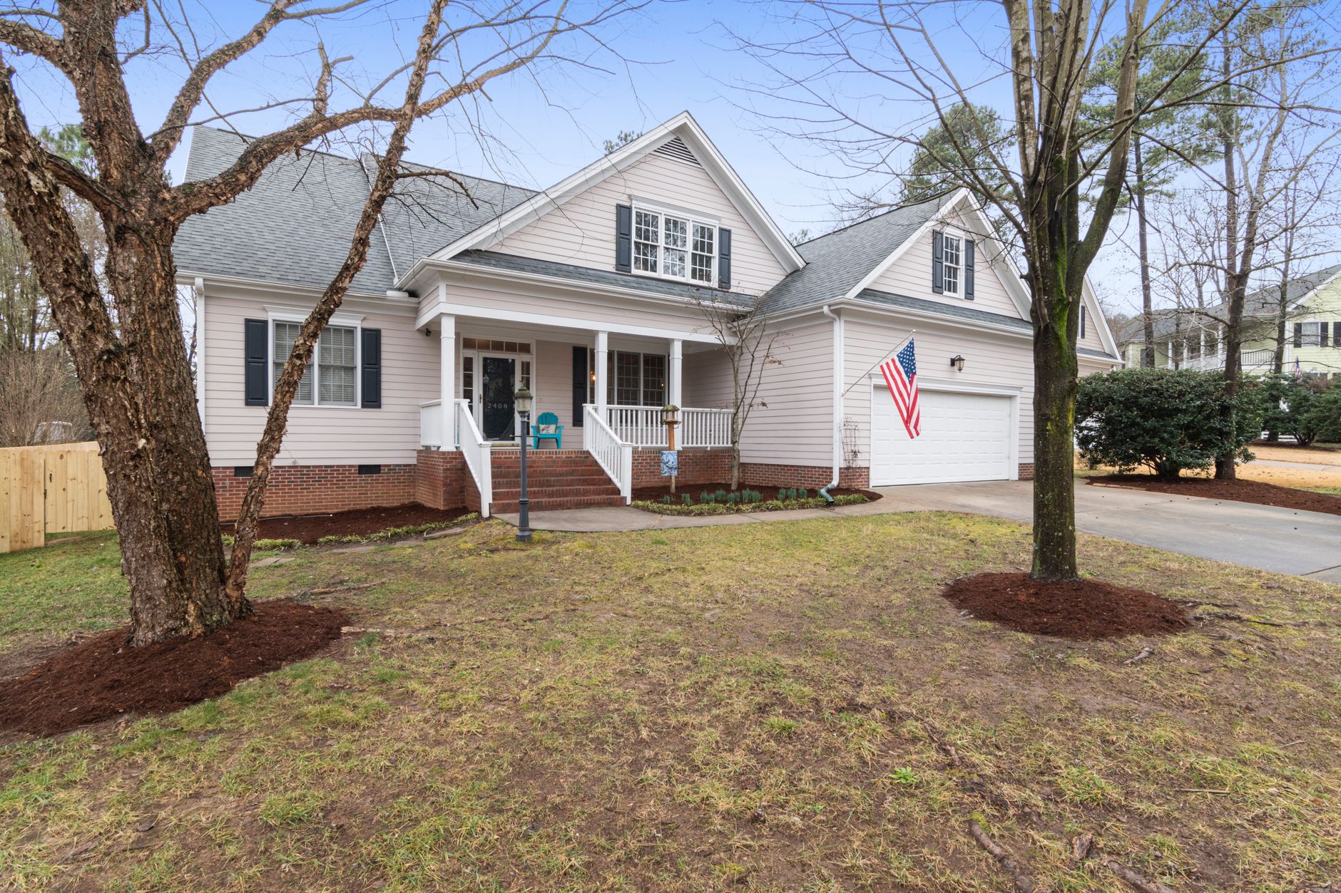 Cozy family home with a welcoming porch and garden, ideal for residential living.