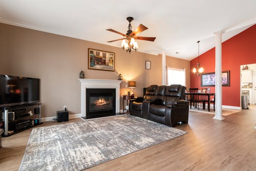 Bright living room featuring a fireplace, comfortable armchairs, and elegant furniture.