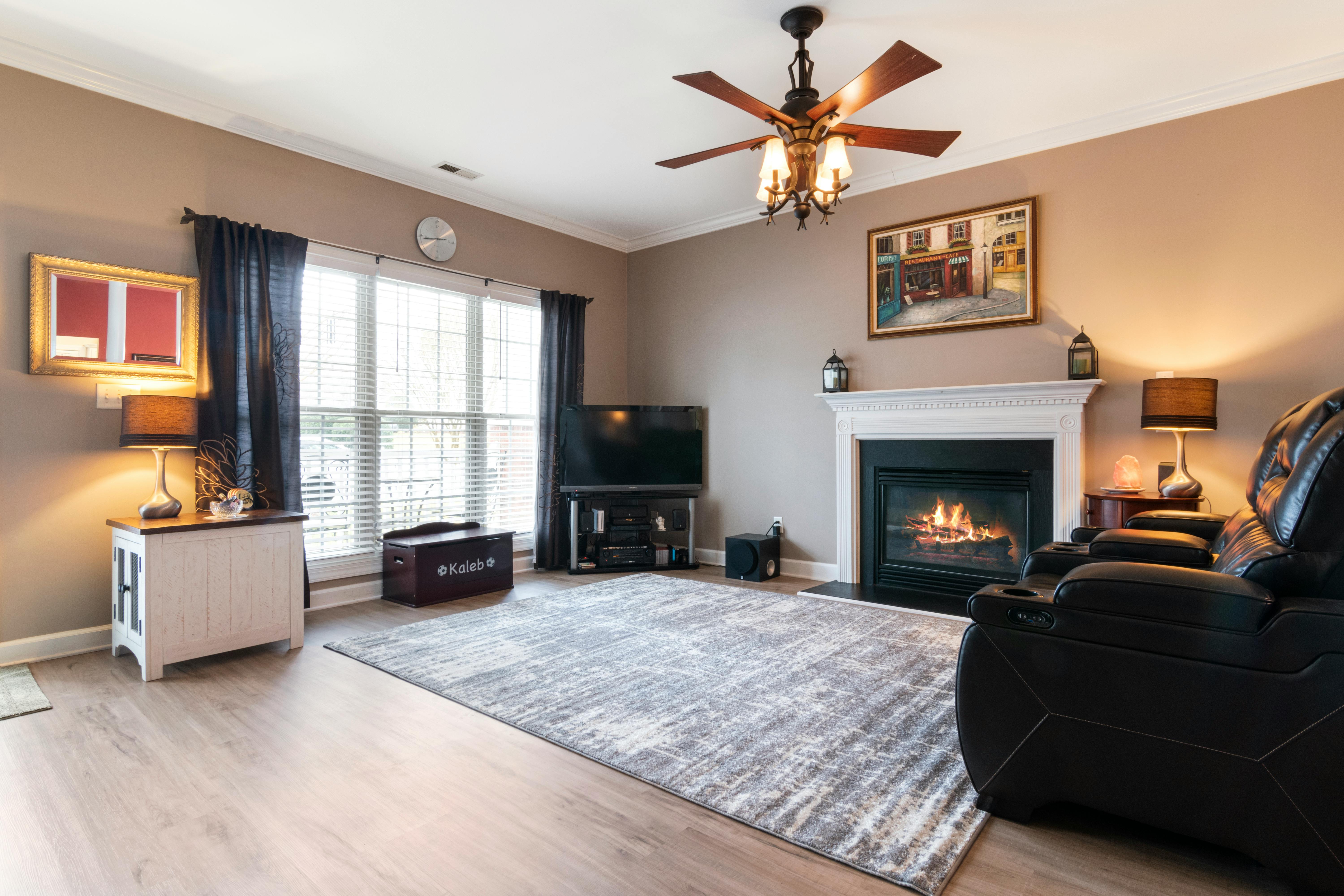 Inviting living space featuring a fireplace, modern decor, and comfortable seating.