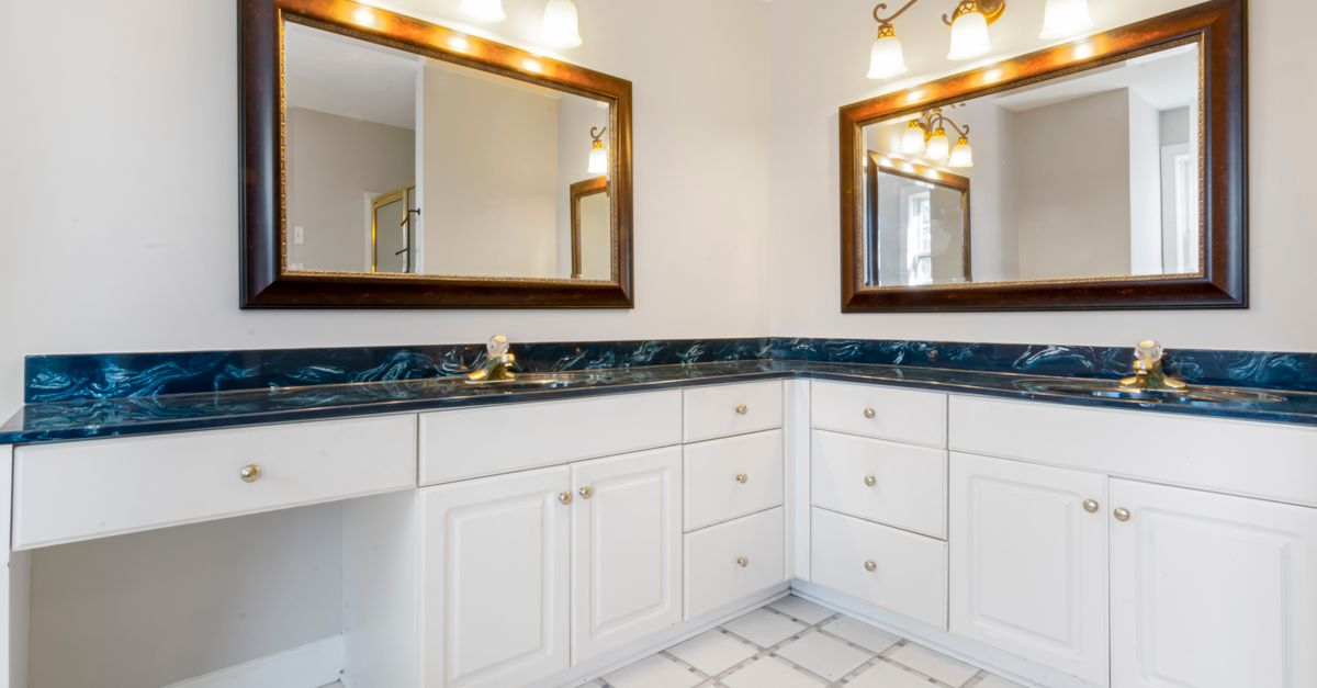 Spacious bathroom with dual mirrors, elegant lighting, and modern countertop design.