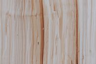 Textured backdrop of cut firewood with rough surface