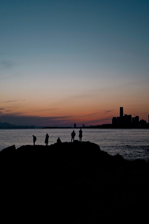 People on Sea Shore at Sunset