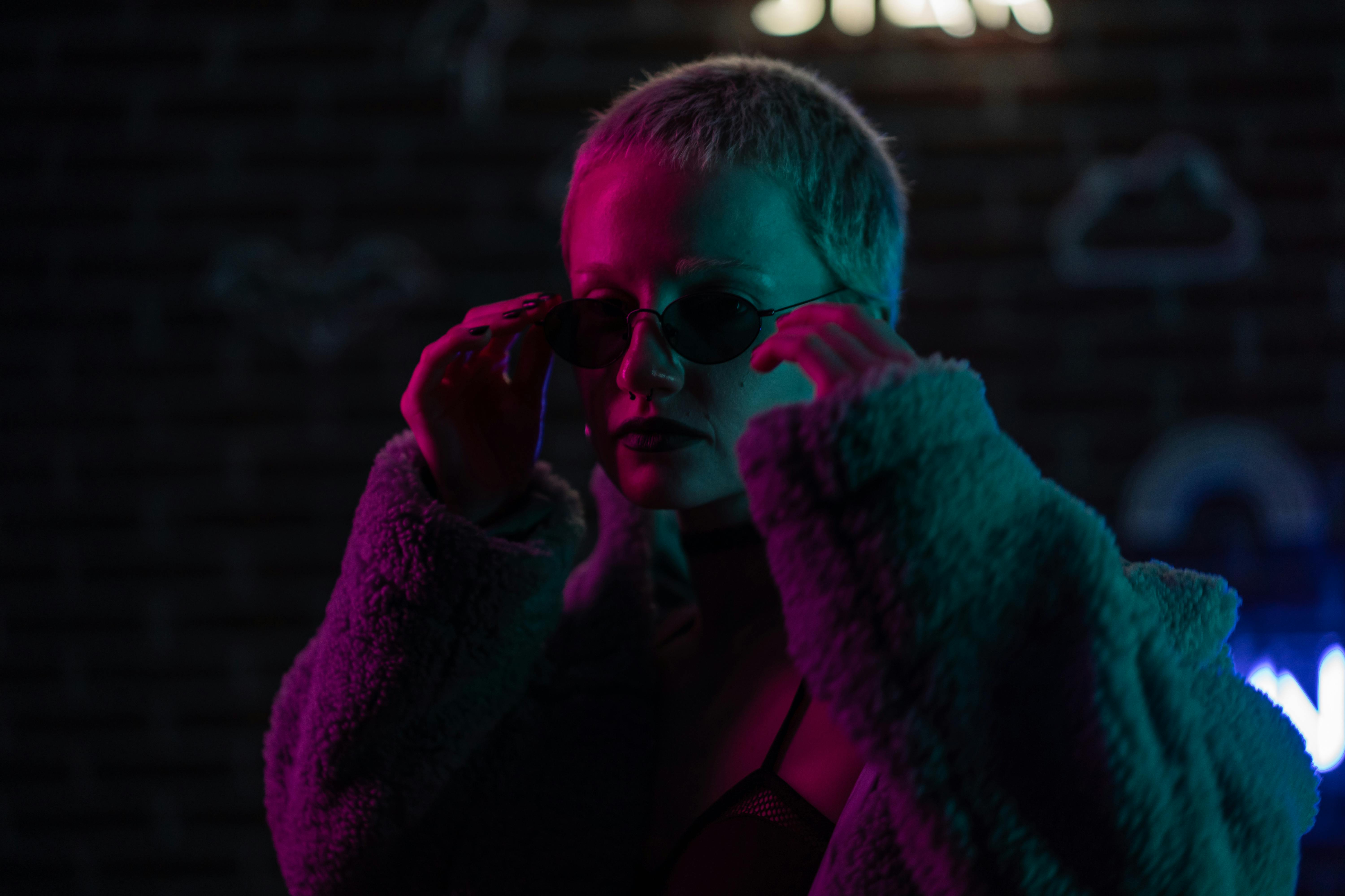 woman in gray coat wearing black framed sunglasses