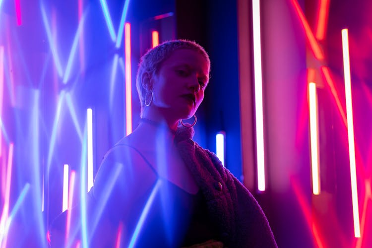 A Woman In Spaghetti Strap Top Near Neon Lights
