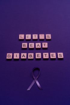Scrabble tiles spell 'Let's Beat Diabetes' with a purple ribbon on a purple background.