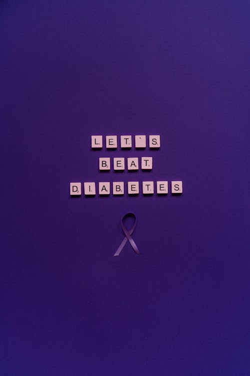 Scrabble Pieces and a Ribbon on the Purple Surface