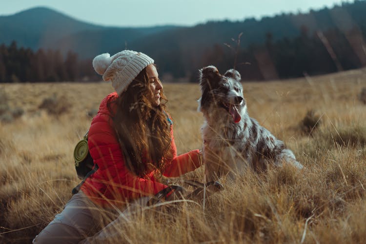 A Woman Sitting With Her Dog