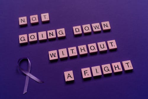 Scrabble Tiles with a Ribbon on Purple Surface