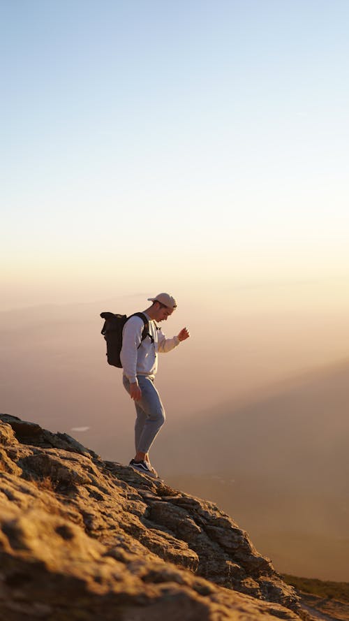 Free Man standing in the Edge of a Cliff Stock Photo
