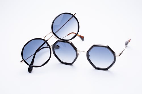 Free Close-Up Shot of Sunglasses on a White Surface Stock Photo