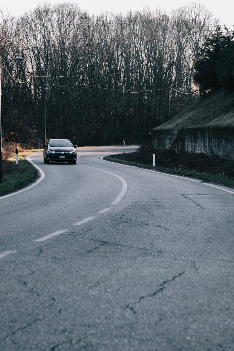 Black Car On Gray Asphalt Road In Tilt Shift