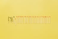 Burnt and Unburn Matchsticks on a Yellow Surface