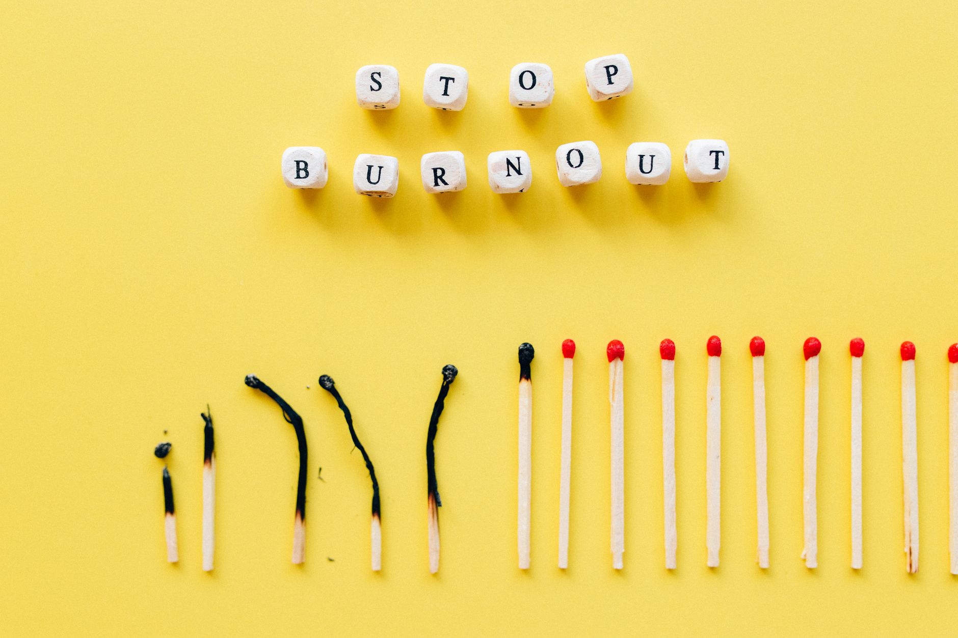 Matchsticks Under Dices with Message on a Yellow Surface