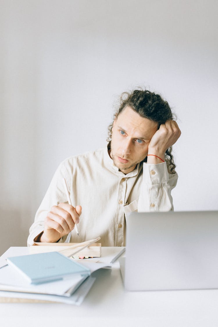 Exhausted Employee In Front Of Laptop 