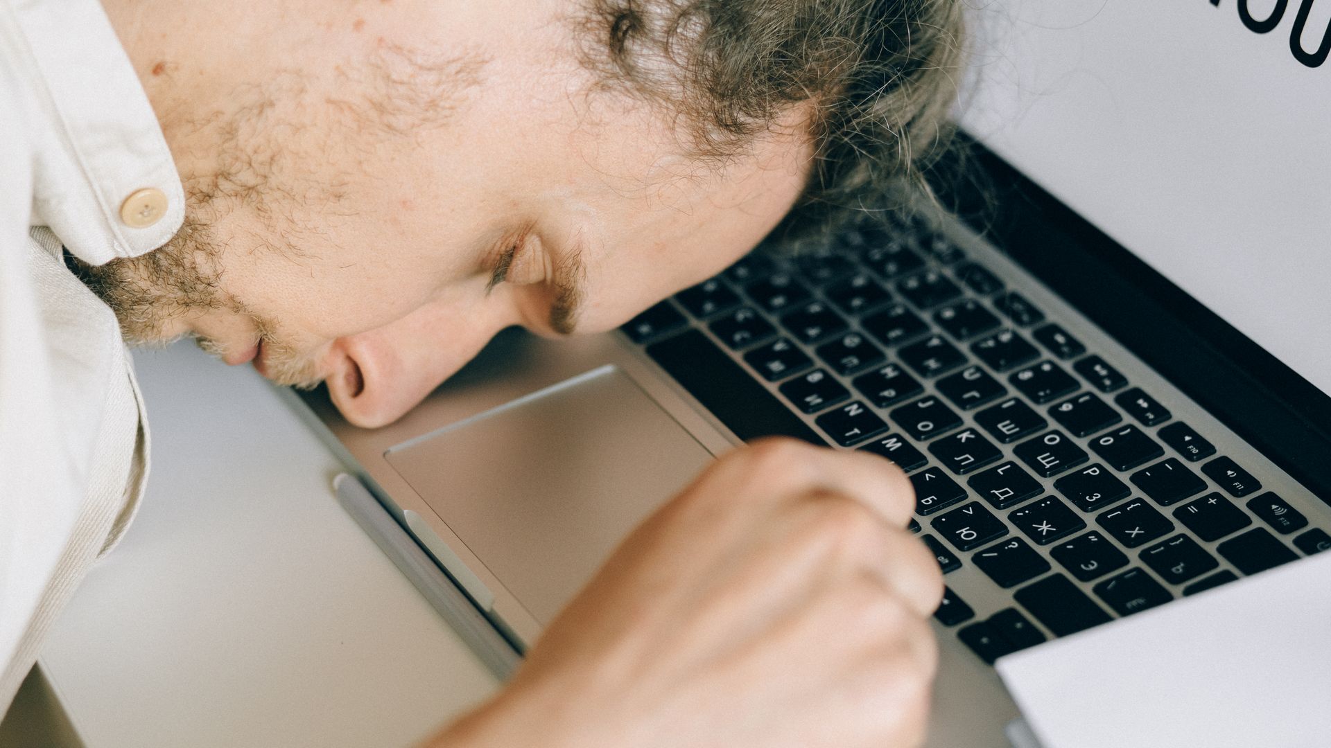 Modafinil and Sleep Schedule: Understanding the Relationship Exhausted employee resting head on laptop keyboard due to burnout and stress — modafinil and sleep schedule