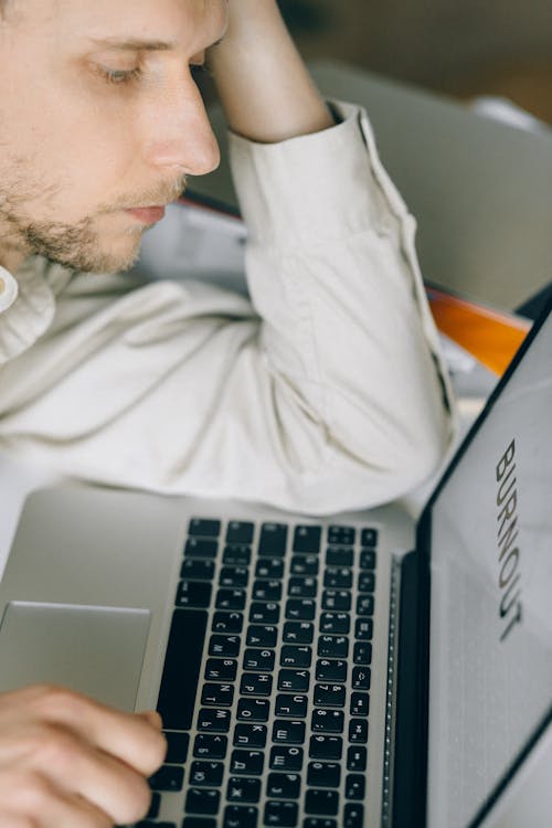 Overworked Employee staring at a Laptop 