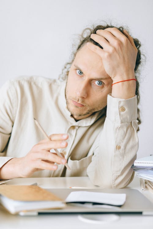 Overworked Employee leaning on the Table Top 