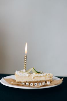 A slice of cake with a candle and burnout spelled in blocks, symbolizing stress.