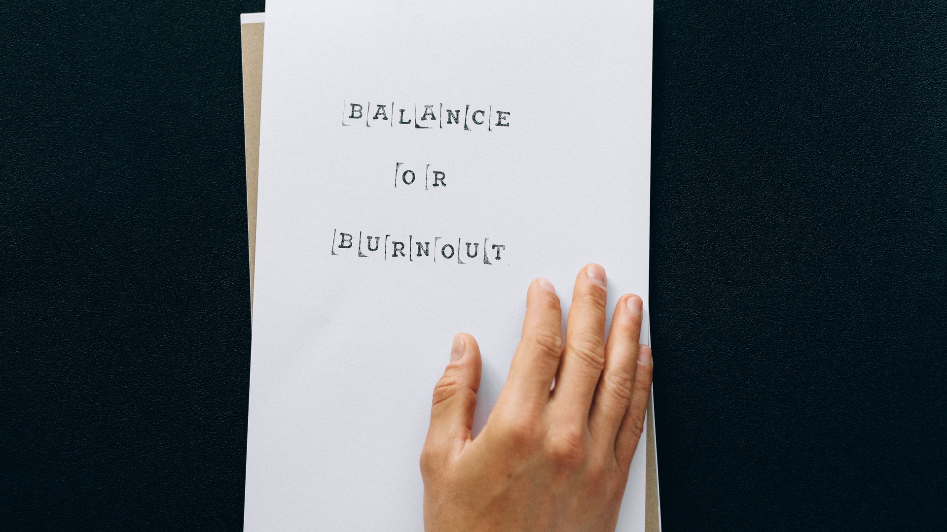 Modafinil for Burnout Recovery: Unlocking Cognitive Resilience Hand holding paper with 'Balance or Burnout' text, promoting mental wellness — modafinil for burnout recovery