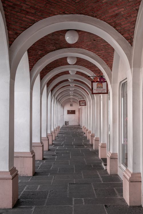 Free Narrow arched hallway with stone flooring in Aguascalientes, Mexico. Stock Photo