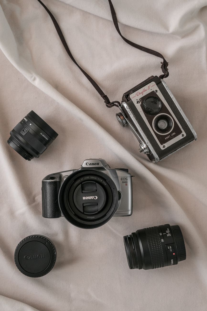 Flat lay of vintage and modern cameras with lenses on fabric background.. flat, vintage, modern