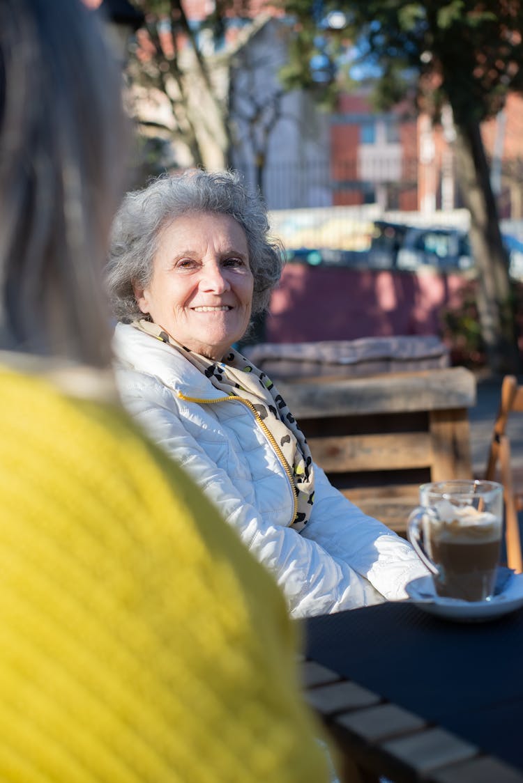 An Elderly Woman In White Jacket Smiling