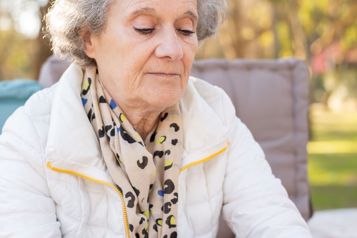 Personne âgée avec un café regardant une tablette le matin