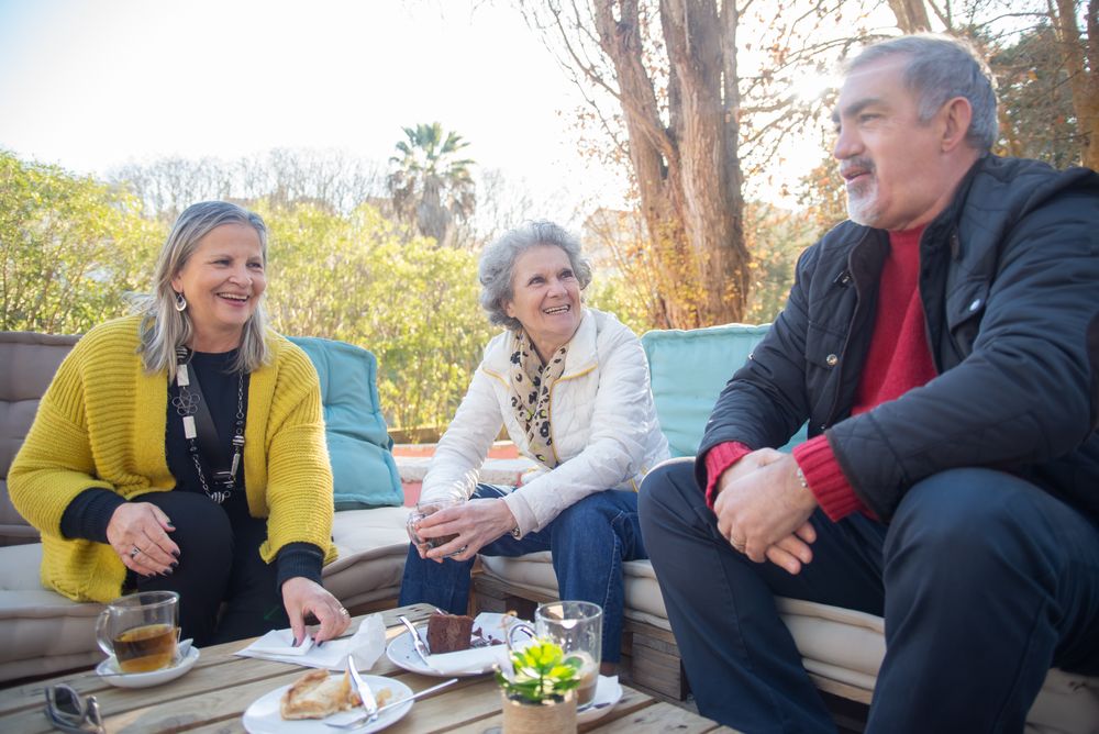 Older friends relaxing with tea in an outdoor setting