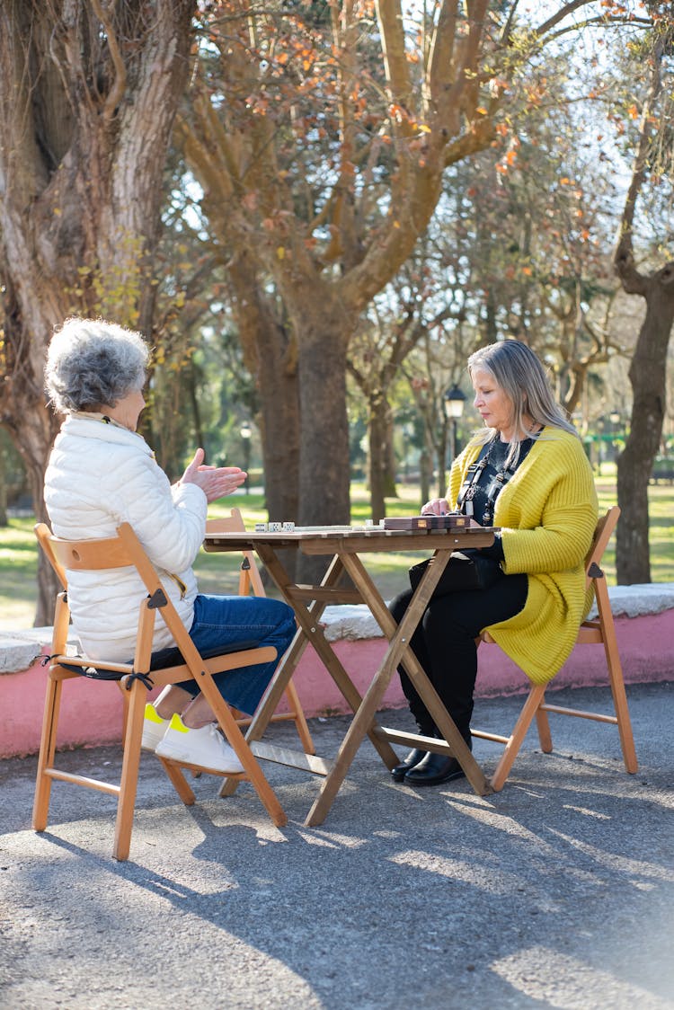 Elderly Woman Playing Domino In The Forest Park