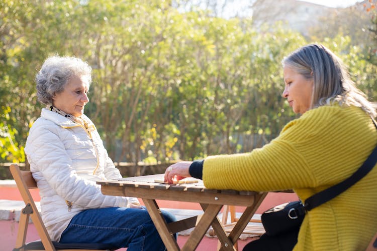 Elderly Women Playing A Game Of Dominoes