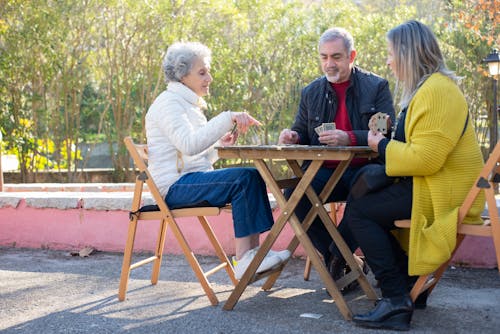 Free Elderly People Playing Cards in the Park Stock Photo