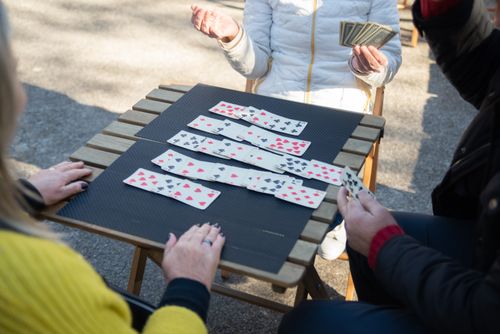 Free People playing an outdoor card game in Portugal, enjoying leisure time. Stock Photo
