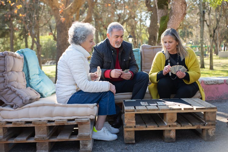 Elderly People Playing Cards At The Park 